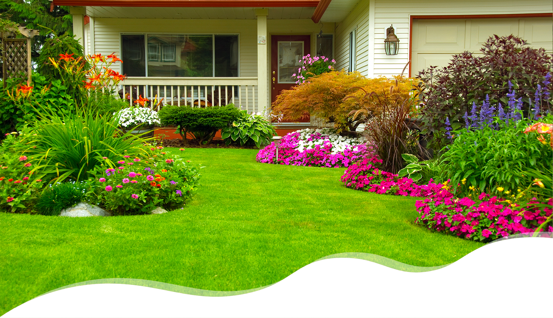 A house with a lawn and flowers in the yard.